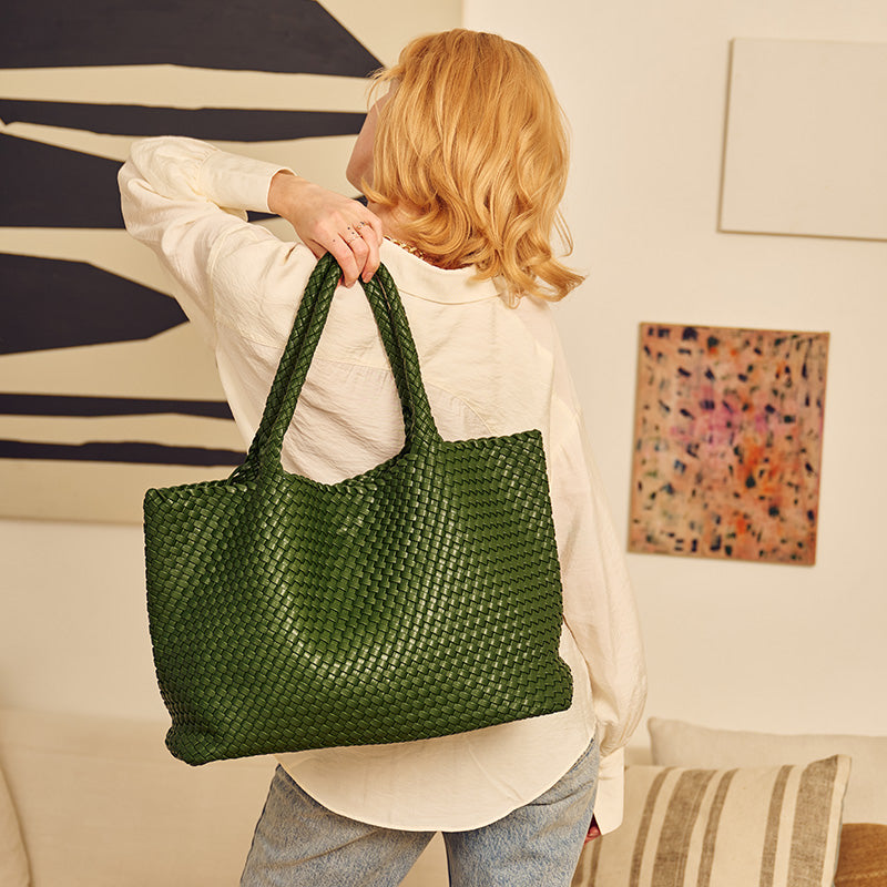 woman holding a green tote