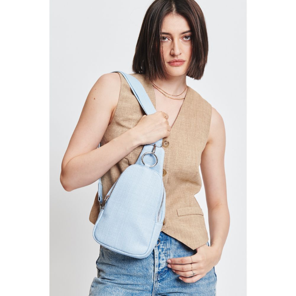 Woman wearing Sky Blue Moda Luxe Regina - Coated Canvas Sling Backpack 842017132608 View 1 | Sky Blue