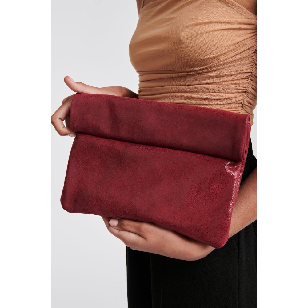 Woman wearing Burgundy Moda Luxe Gianna Metallic Clutch 842017115397 View 1 | Burgundy