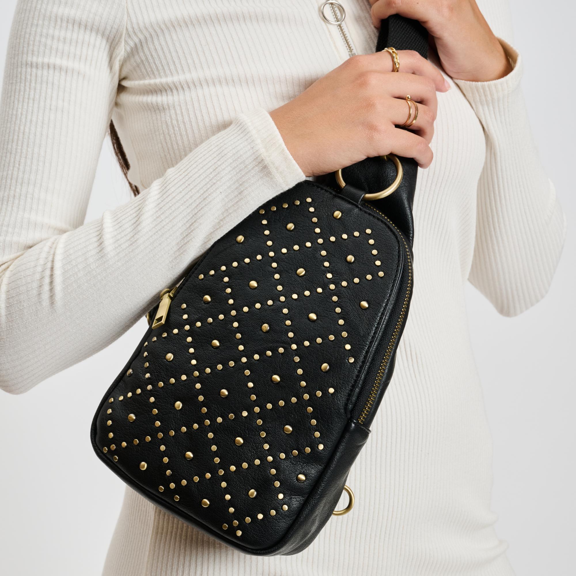 Woman wearing Black Moda Luxe Regina Studded Sling Backpack 842017136804 View 1 | Black