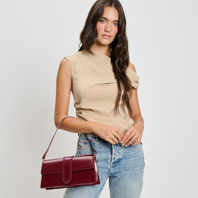 Woman wearing Burgundy Moda Luxe Violet - Patent Crossbody 842017136620 View 1 | Burgundy