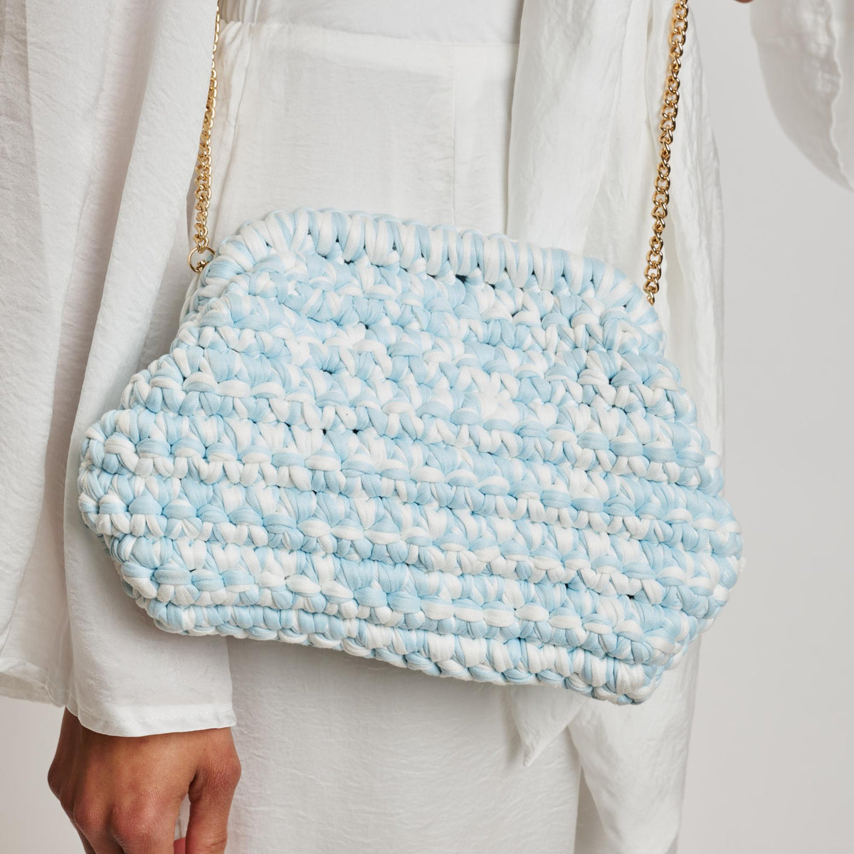 Woman wearing Ice Blue Moda Luxe Raya Clutch 842017138396 View 1 | Ice Blue