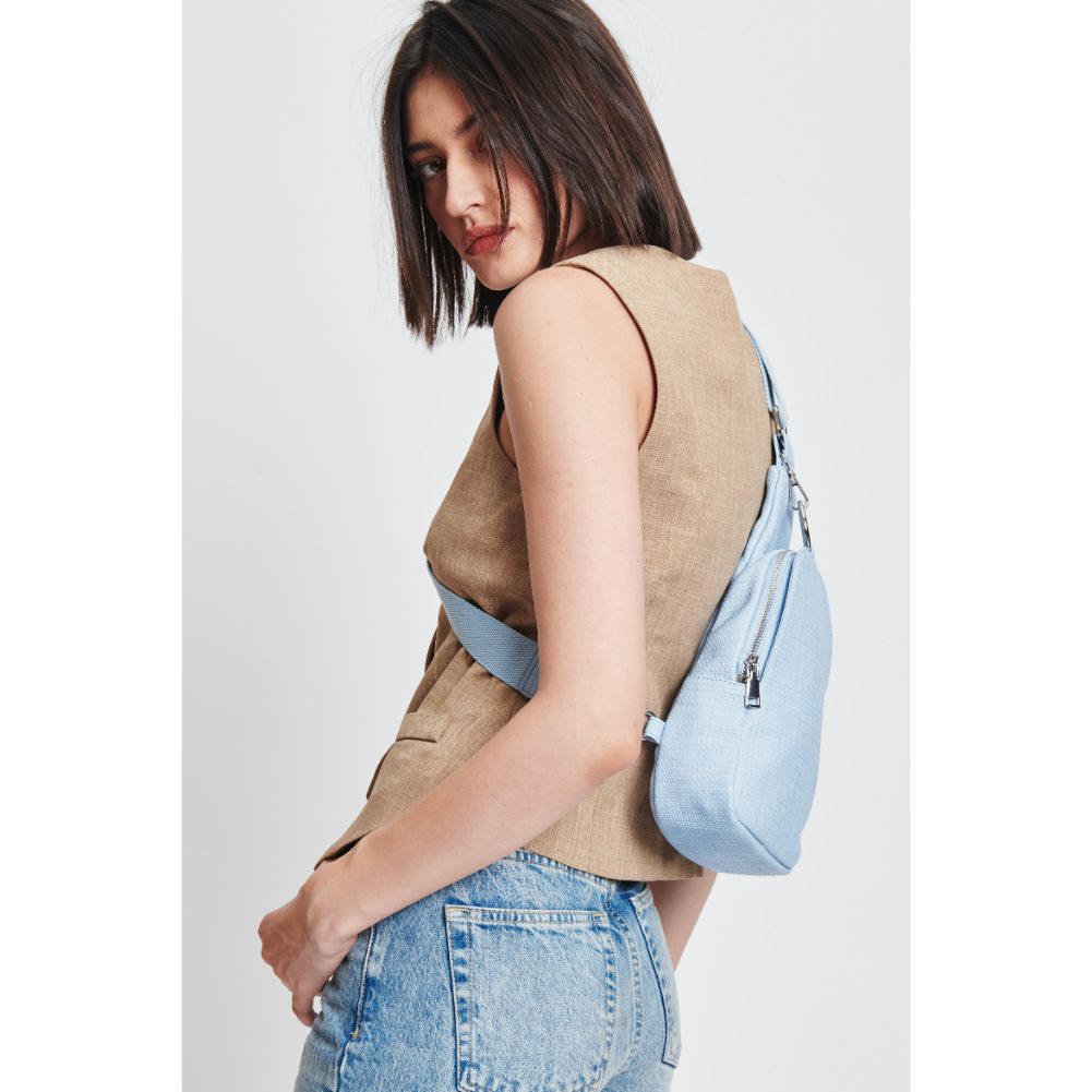 Woman wearing Sky Blue Moda Luxe Regina - Coated Canvas Sling Backpack 842017132608 View 2 | Sky Blue